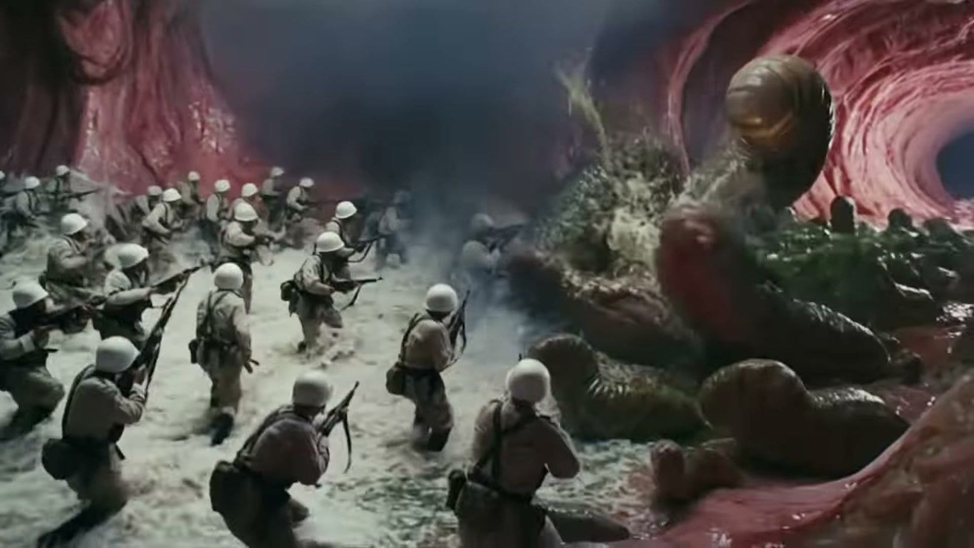Dozens of helmeted soldiers with rifles wade forward across a pale, foaming floor towards a heaped mass of green and brown bacteria banked against the red, ridged wall of a gut tunnel, with smoke drifting between the two sides